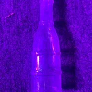 Vintage condiment bottle with unique shape.